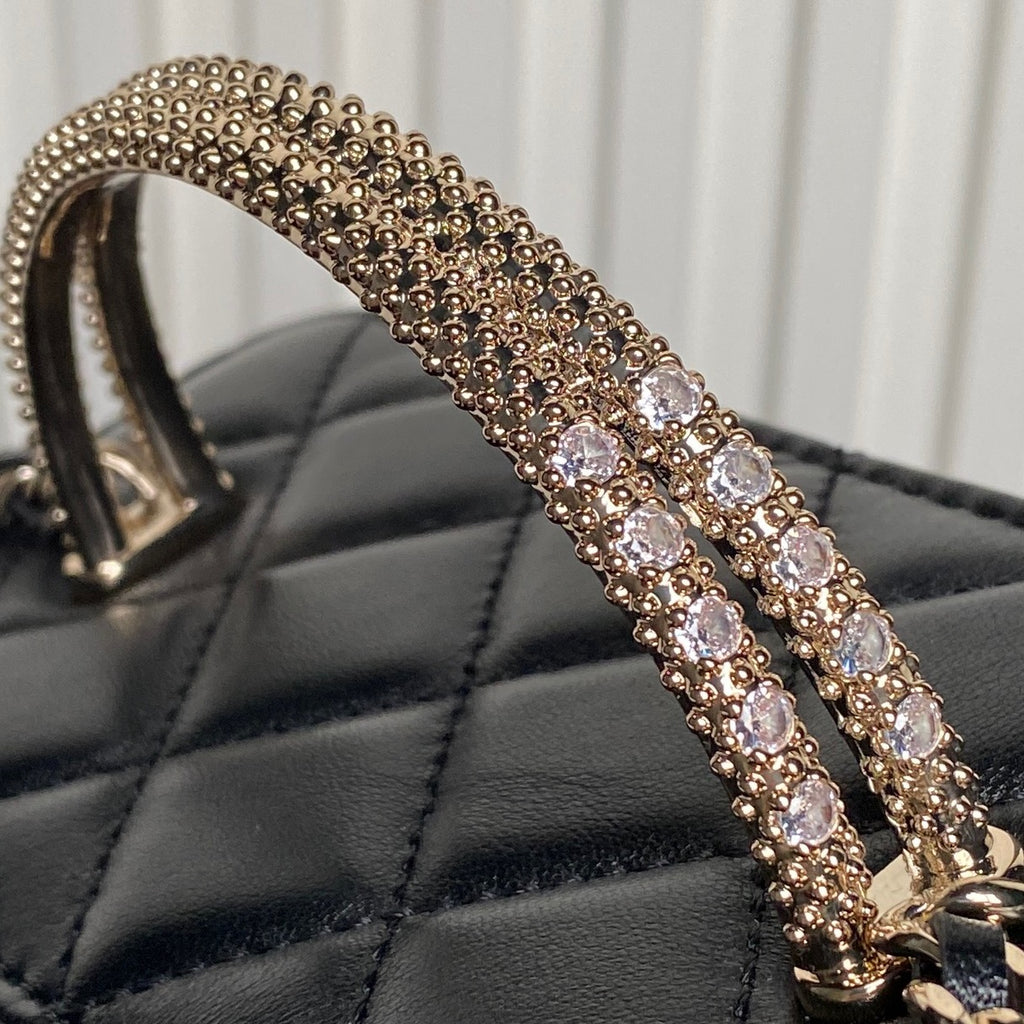 Rhinestone-embellished gold-tone strap on black quilted mini bag