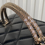 Rhinestone-embellished gold-tone strap on black quilted mini bag