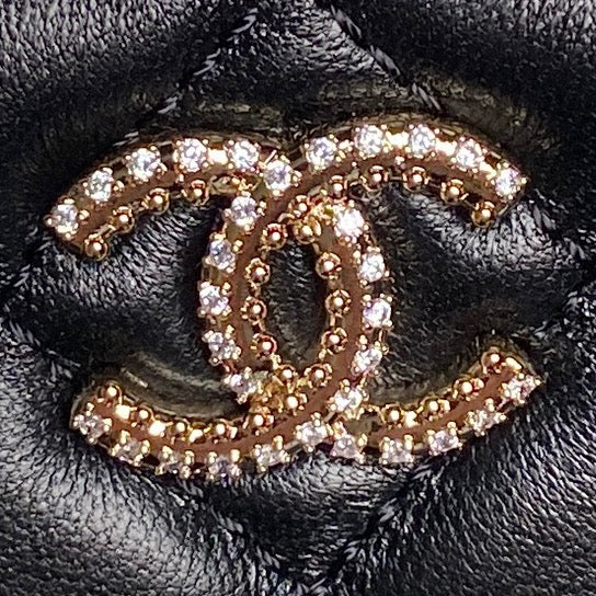 Black leather mini bag with gold-tone rhinestone Chanel logo