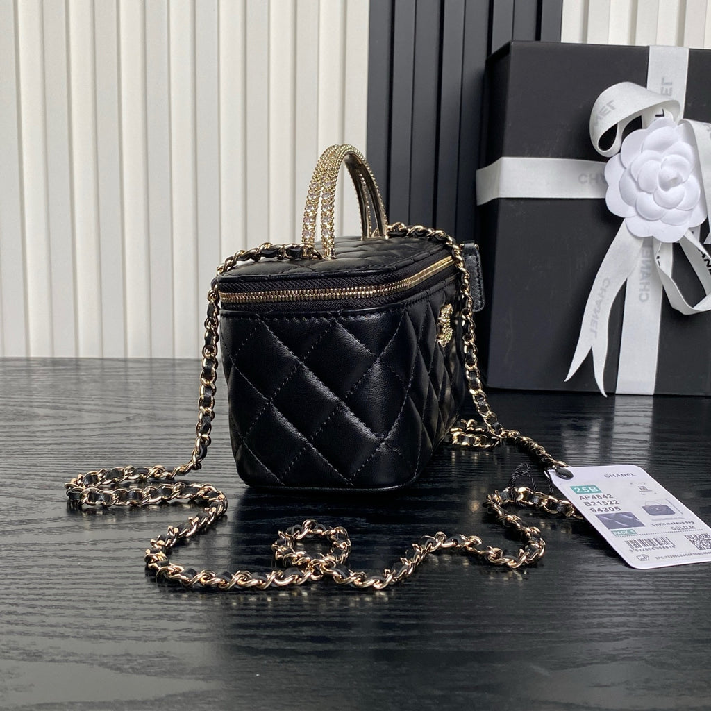 Black quilted mini bag with gold chain strap, zip-top and Chanel logo