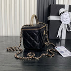 Black quilted mini bag with gold chain strap, zip-top and Chanel logo