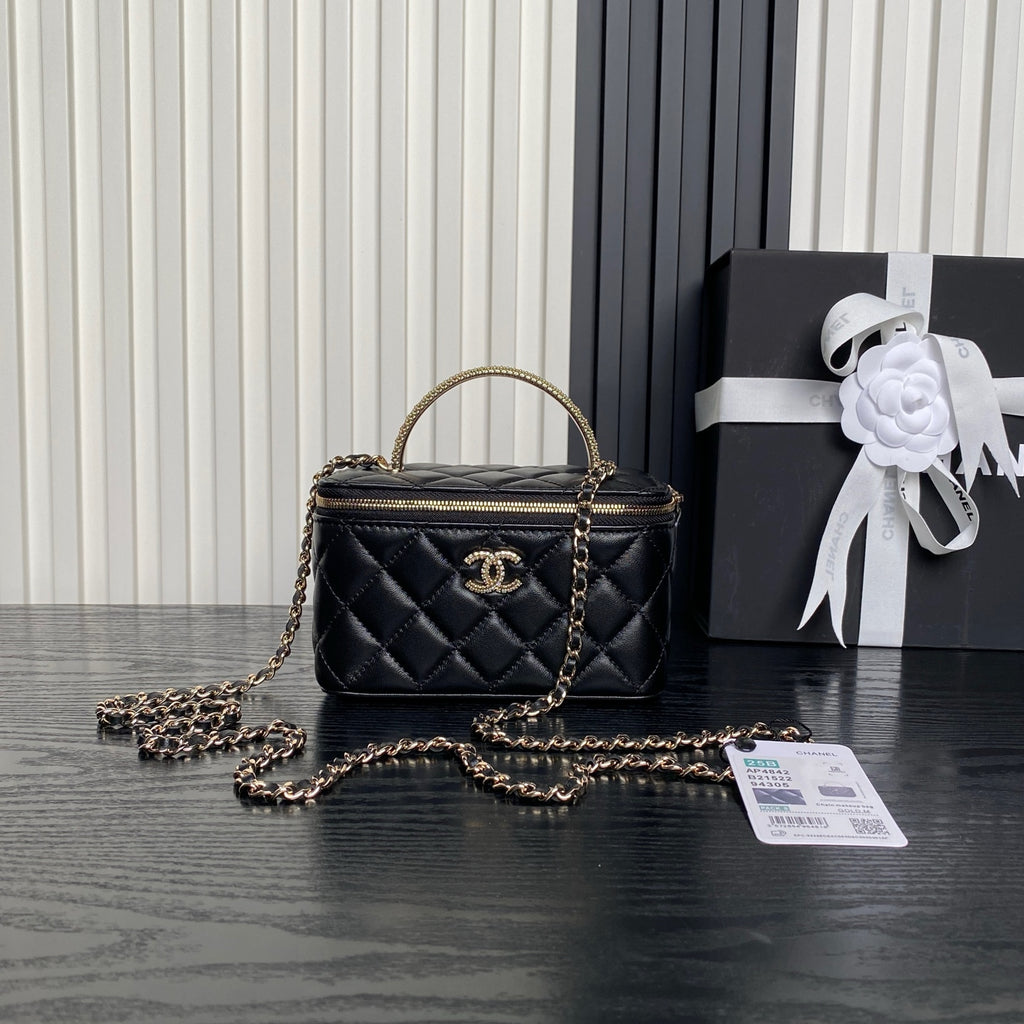 Black quilted mini crossbody bag with gold chain strap and Chanel logo on front