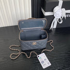 Open blue quilted mini handbag with zipper, interior compartments, and gold trim