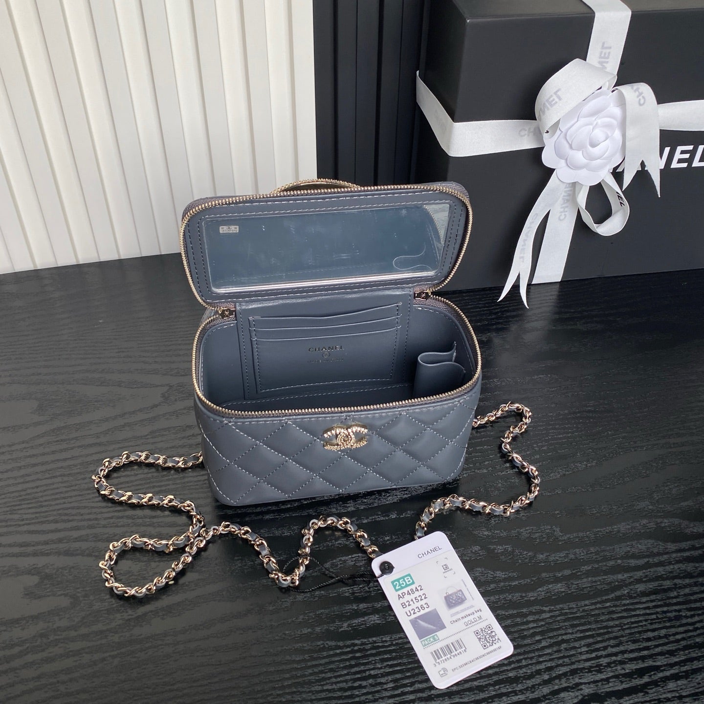 Open blue quilted mini handbag with zipper, interior compartments, and gold trim
