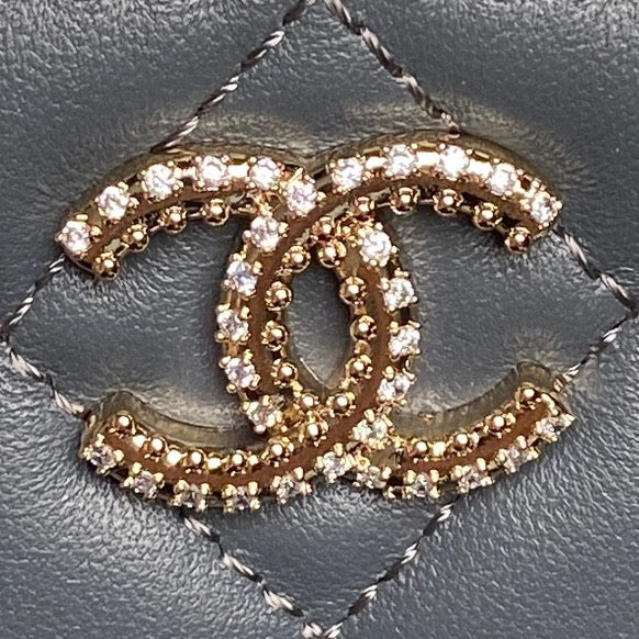 Rhinestone CC medallion on blue quilted leather mini handbag front
