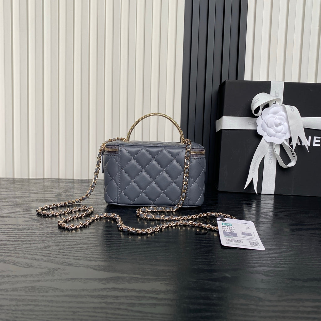 Quilted navy mini handbag with gold chain strap and CC logo, plus zipper top