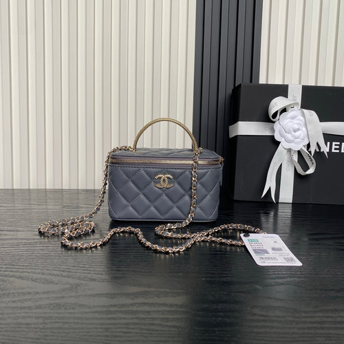 Quilted navy mini handbag with top handle, gold chain strap, and front CC logo