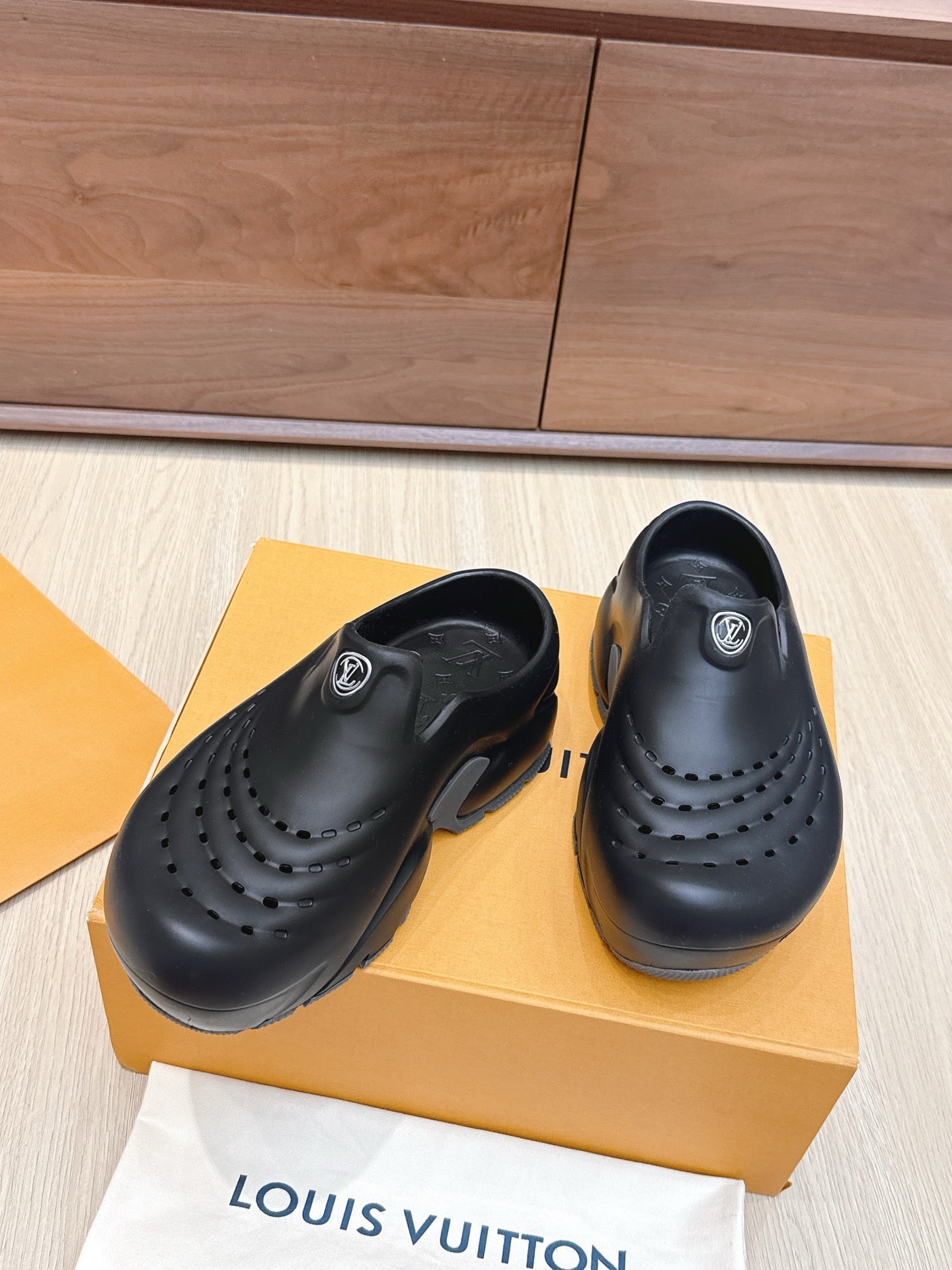 Louis Vuitton black clogs with toe perforations and logo patch on vamp