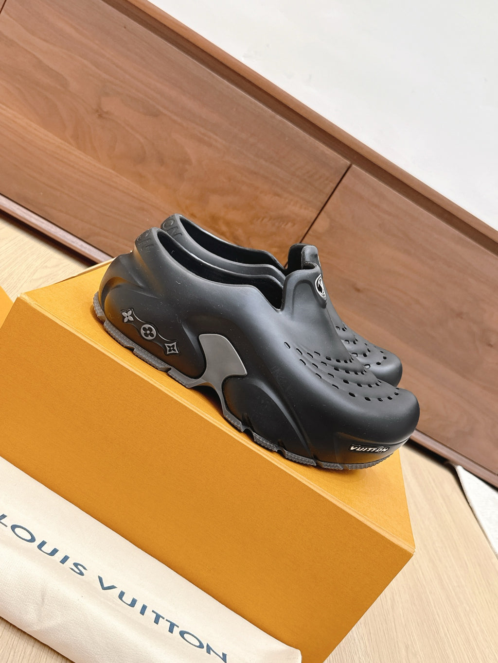 Louis Vuitton dark slip-on clogs with side cutouts and perforated upper