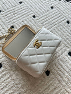 Chanel quilted mini bag with front CC logo and gold-framed phone slot, white