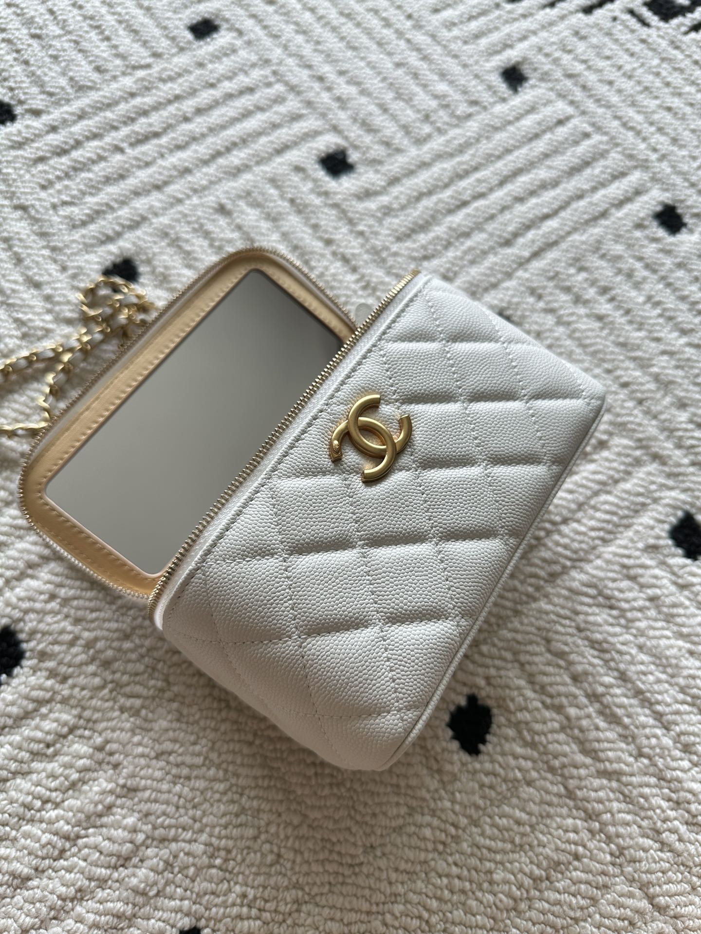 Chanel quilted mini bag with front CC logo and gold-framed phone slot, white