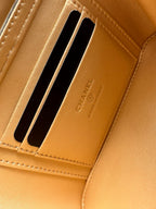 Chanel wallet card slot close-up with CHANEL embossed on tan interior lining
