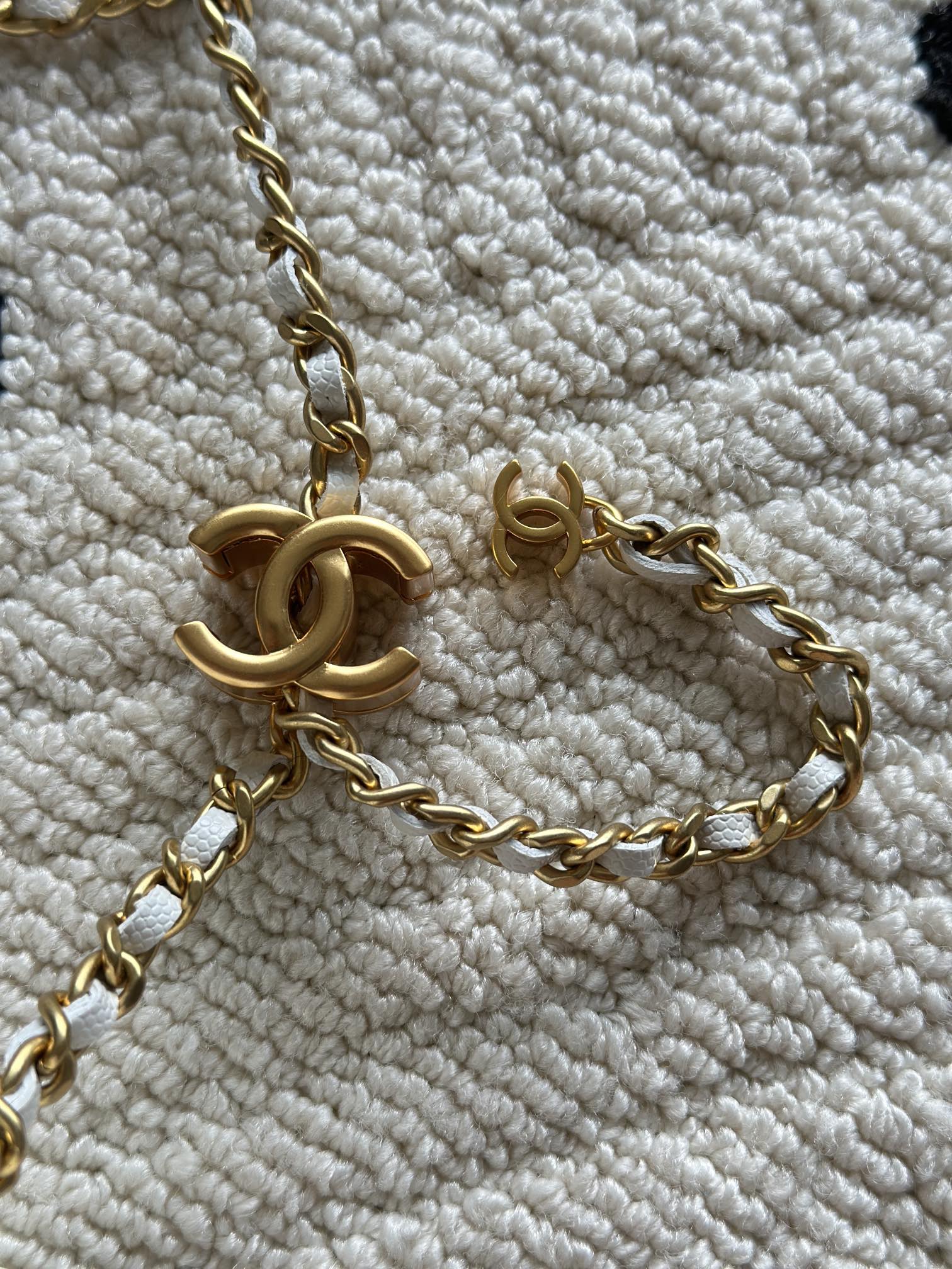 Chanel quilted mini bag chain strap close-up with gold hardware and CC charm