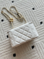 Chanel quilted mini bag, white, side view with gold chain strap and flap