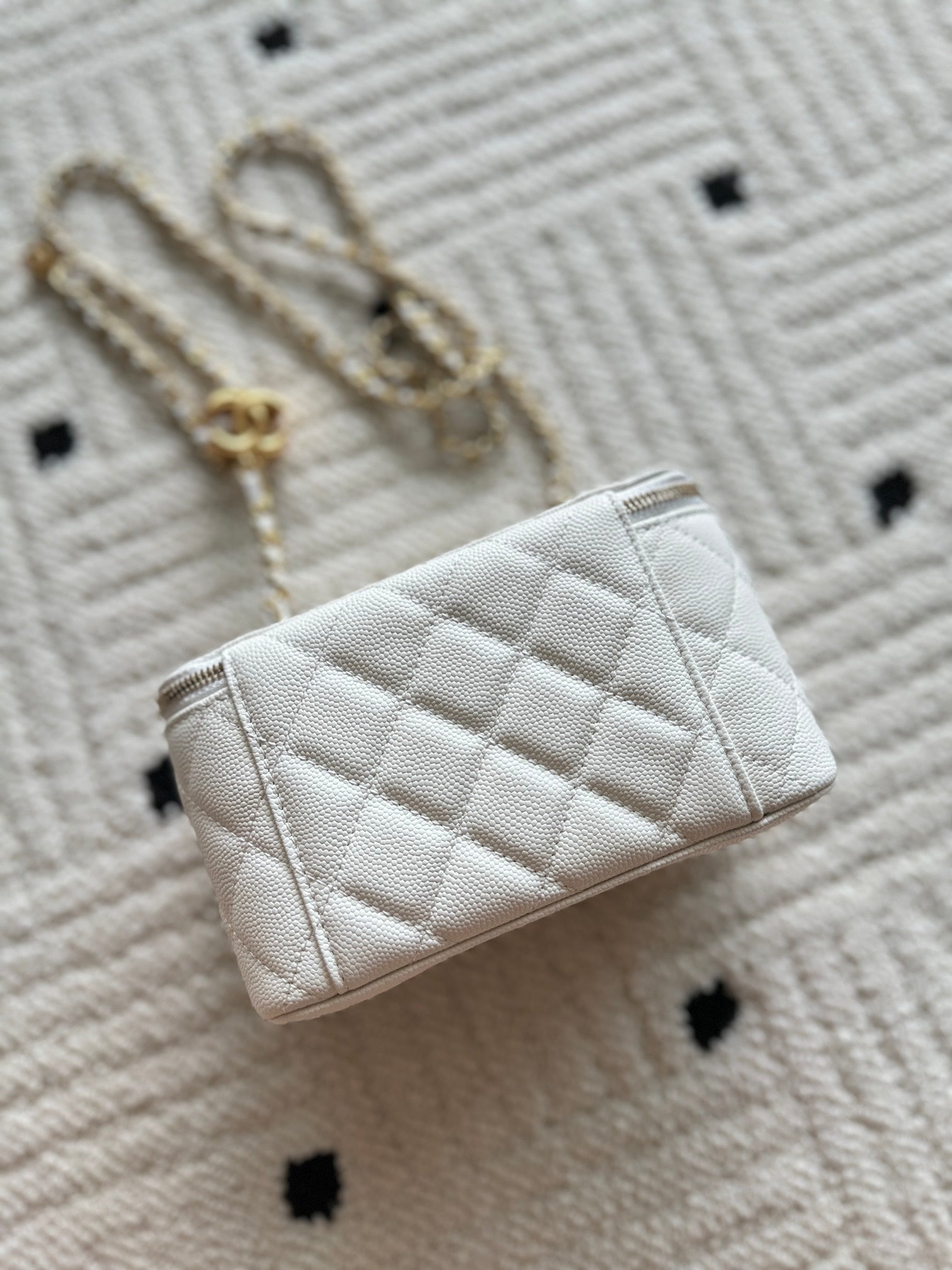 Chanel quilted mini bag, white, side view with gold chain strap and flap