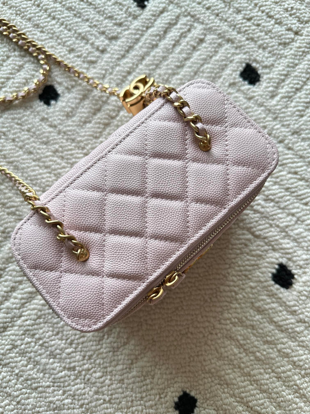Pink quilted Chanel mini shoulder bag with gold chain strap and front logo
