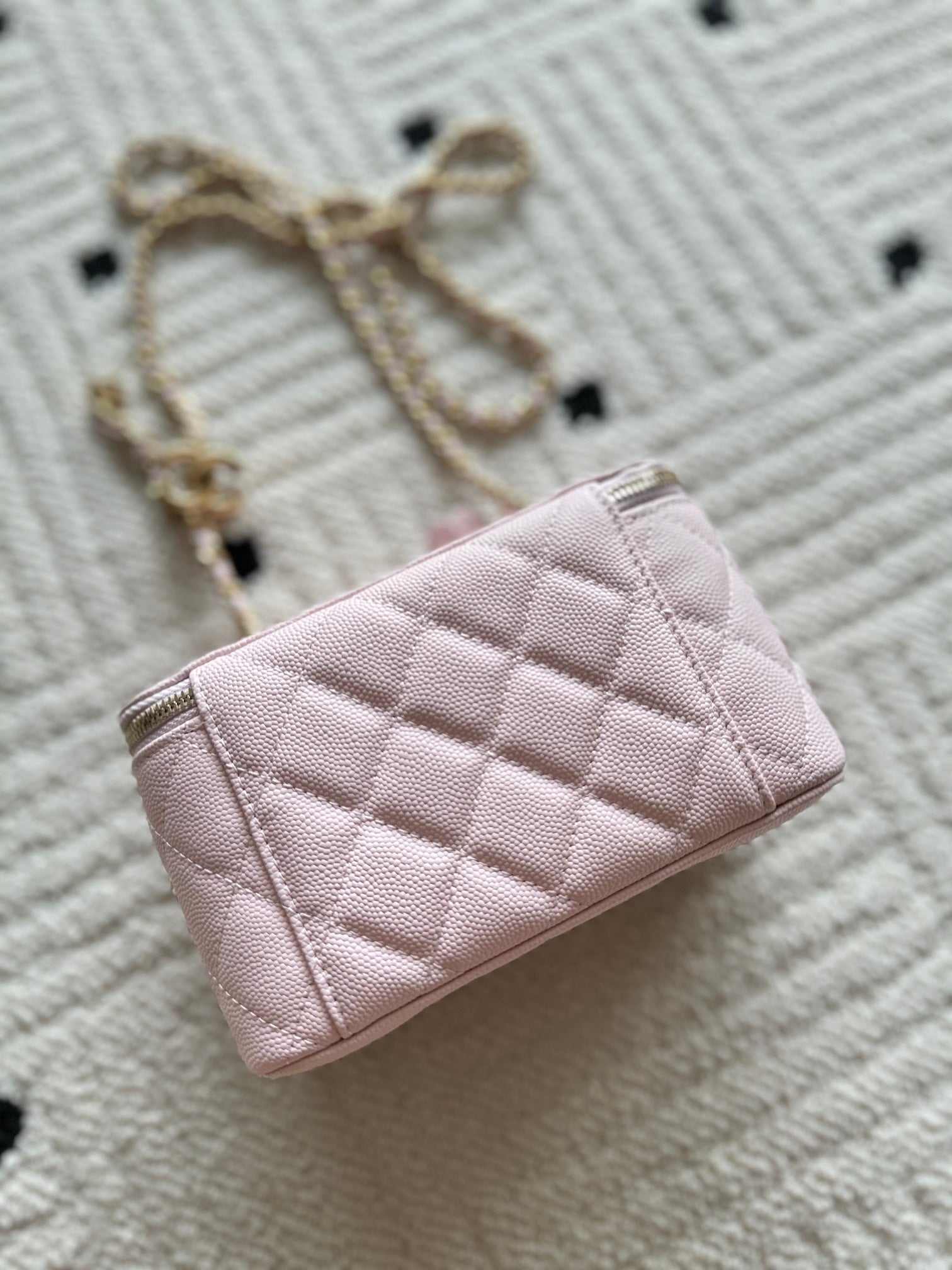 Pink quilted Chanel mini bag with gold chain handle, front facing