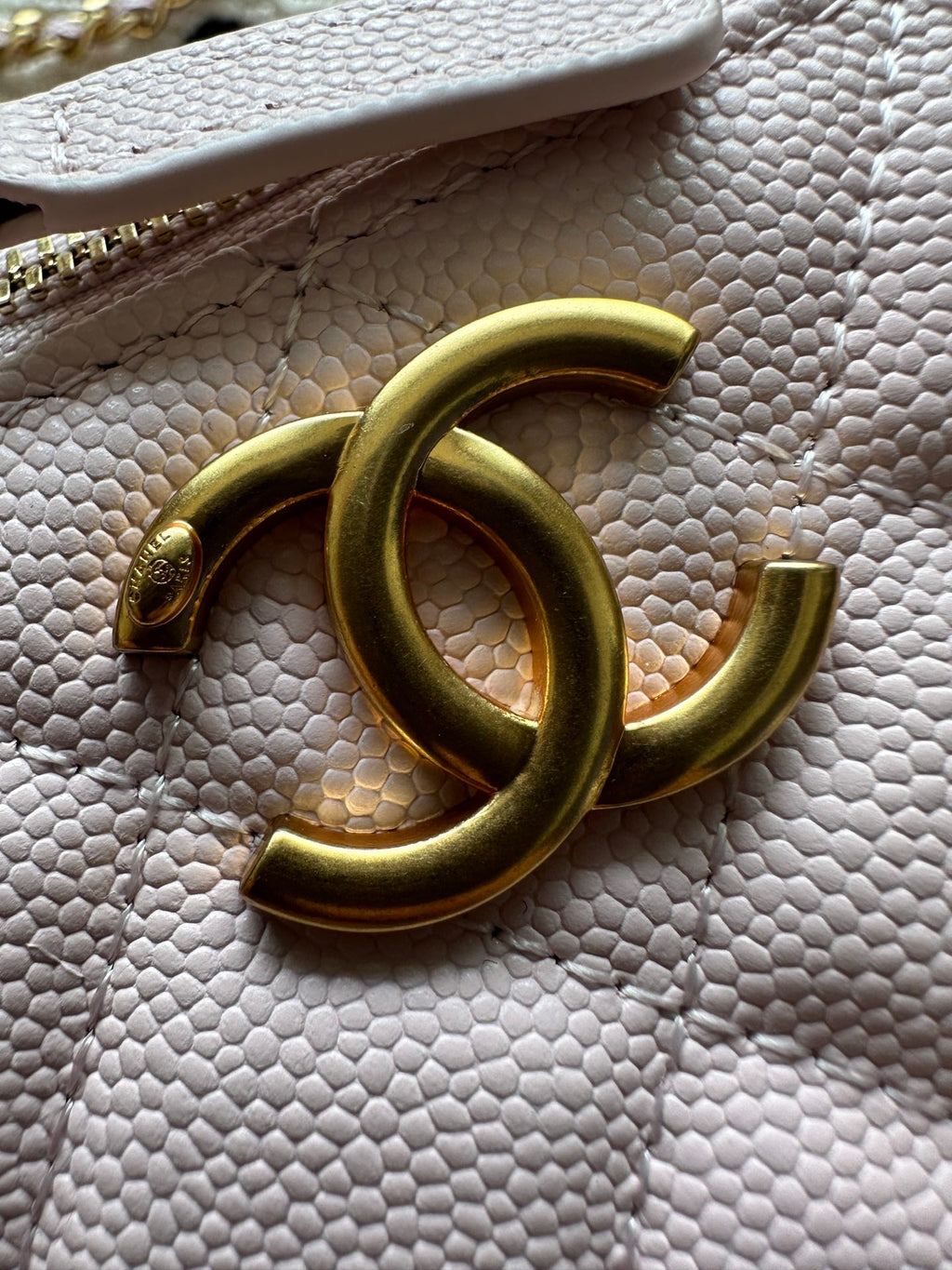 Gold-tone CC clasp on Chanel bag hardware with chain link