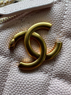 Gold-tone CC clasp on Chanel bag hardware with chain link