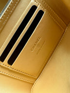 Gold Chanel cardholder section with two black-lined slots and embossed branding