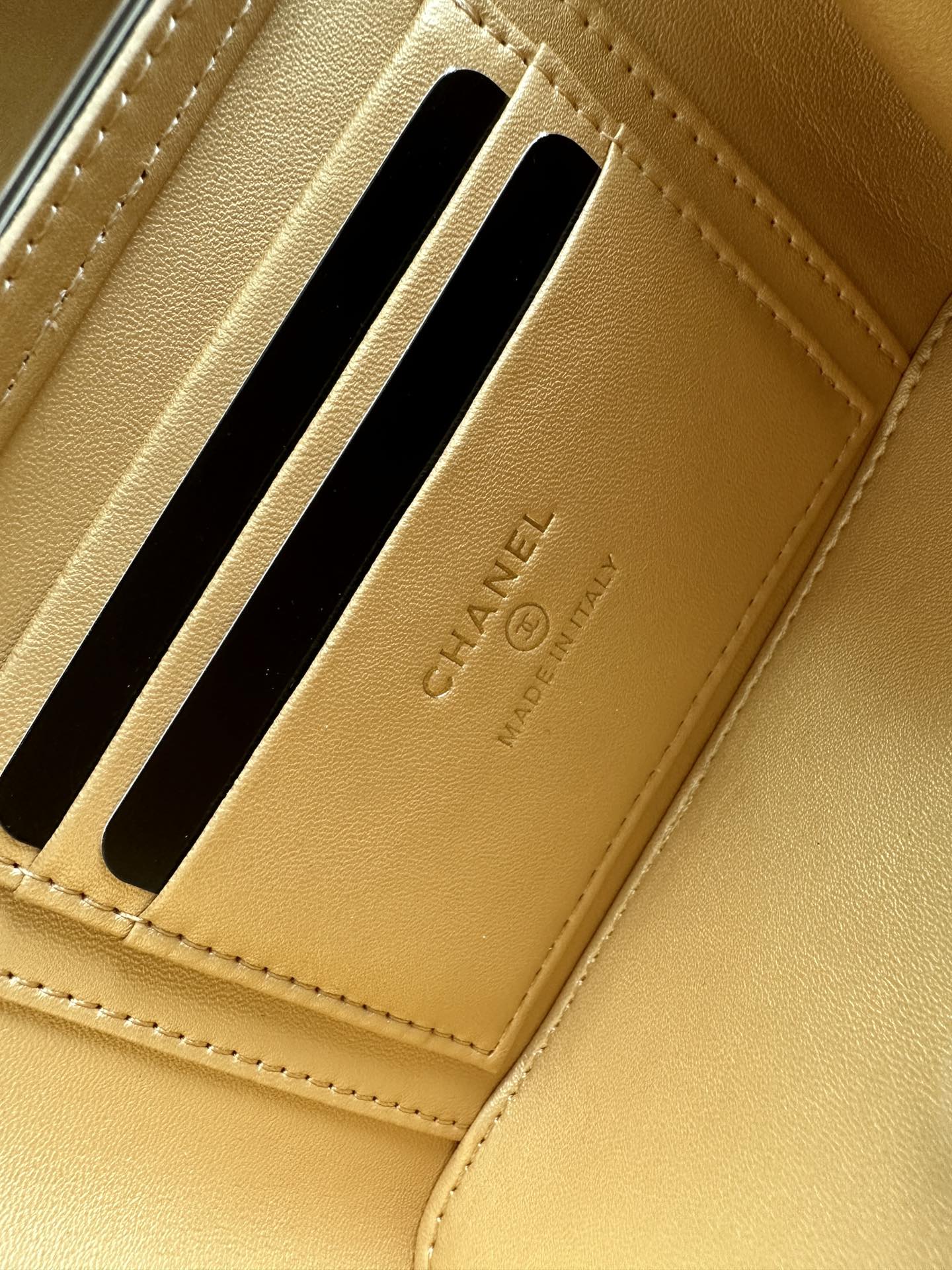 Gold Chanel cardholder section with two black-lined slots and embossed branding