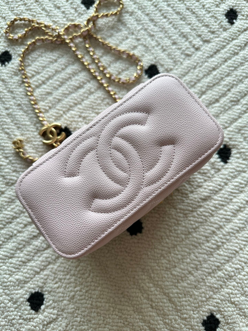 Pink Chanel quilted mini bag with CC logo and gold chain strap
