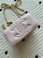 Pink Chanel quilted mini bag with CC logo and gold chain strap