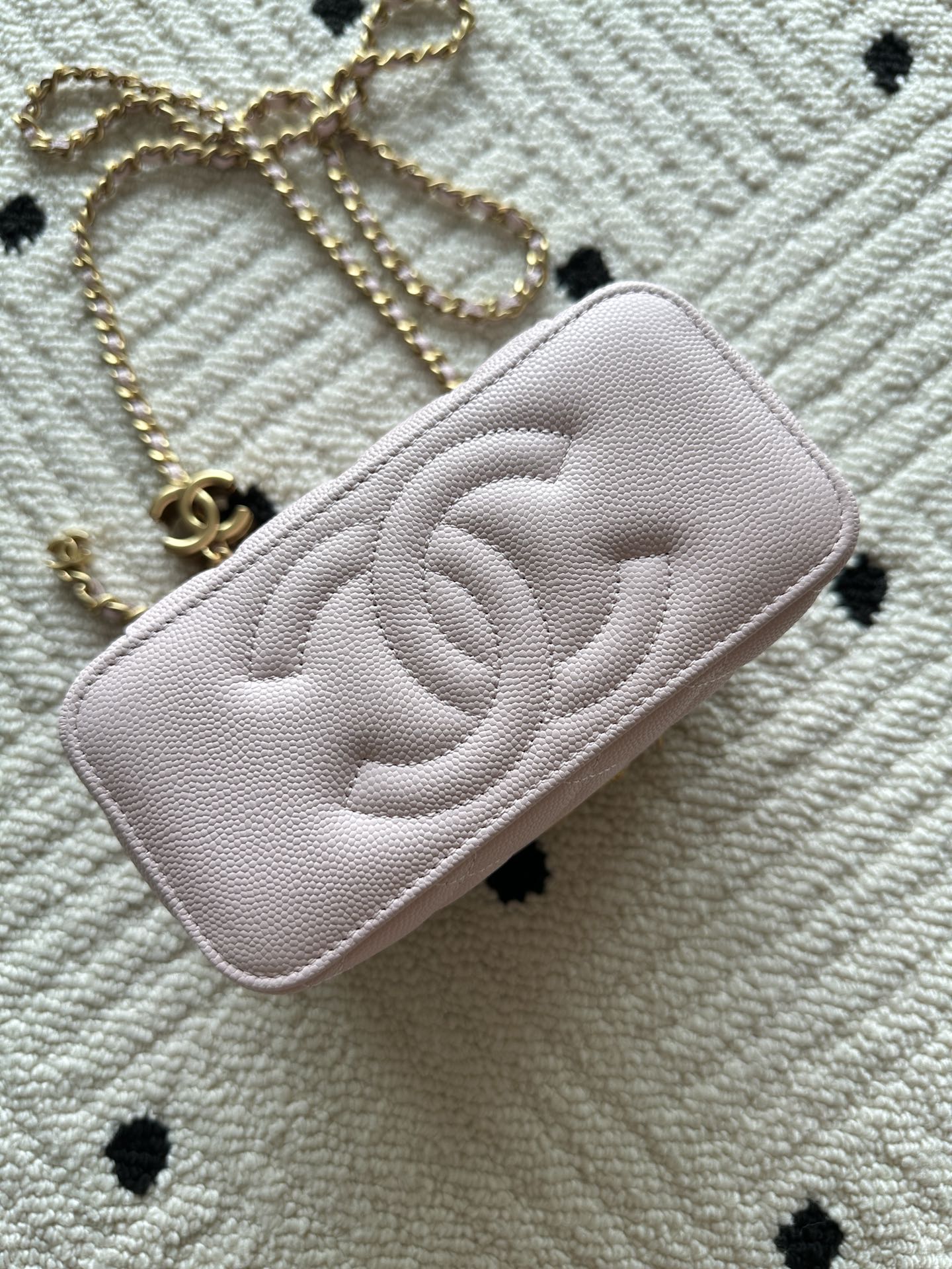 Pink Chanel quilted mini bag with CC logo and gold chain strap