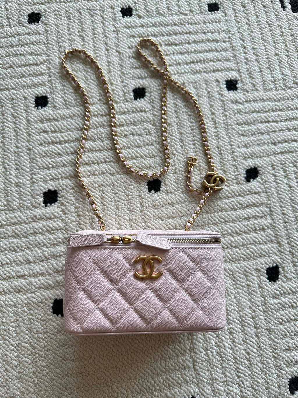Pink quilted Chanel mini bag with top zip and gold chain strap