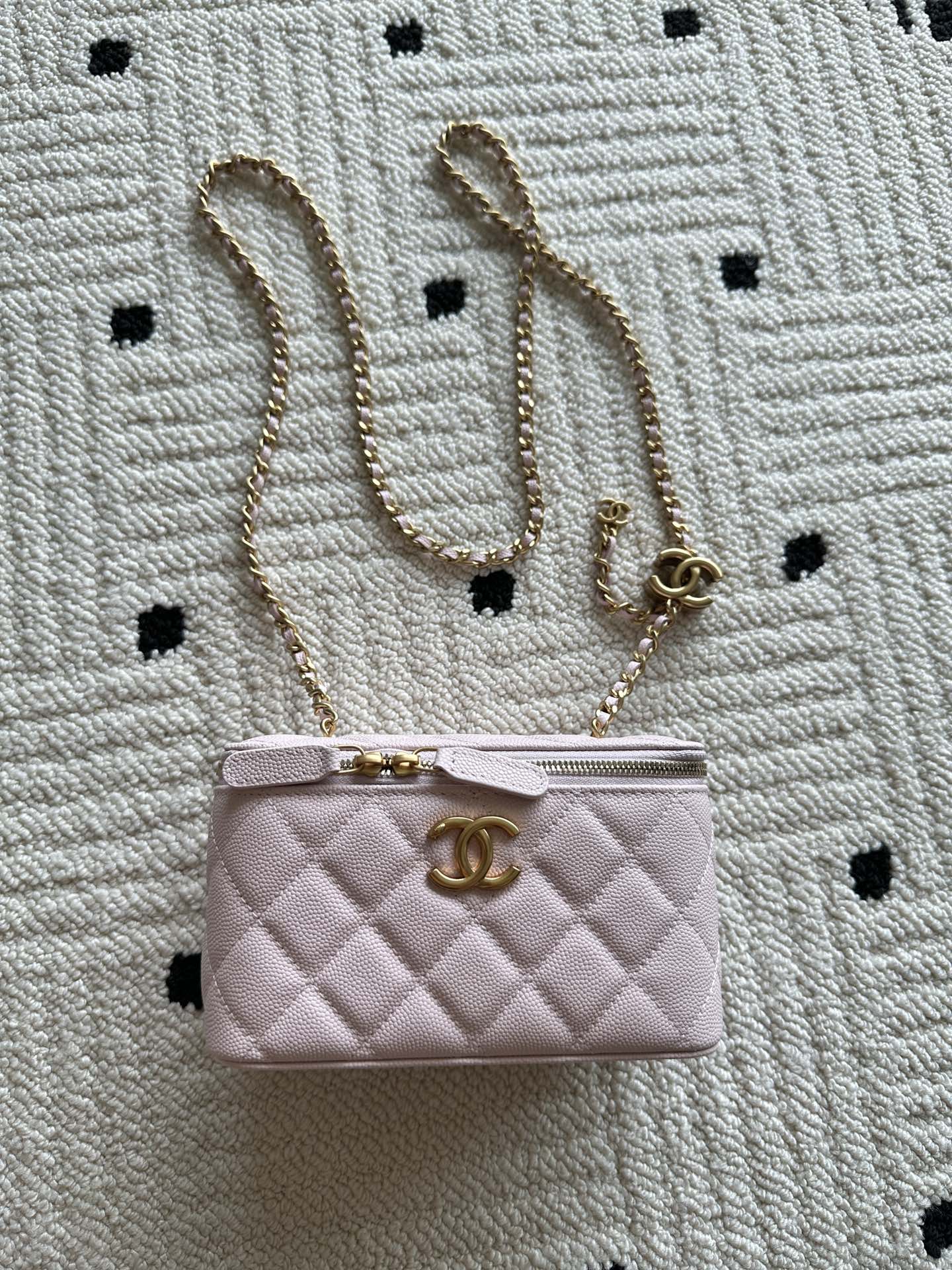Pink quilted Chanel mini bag with top zip and gold chain strap