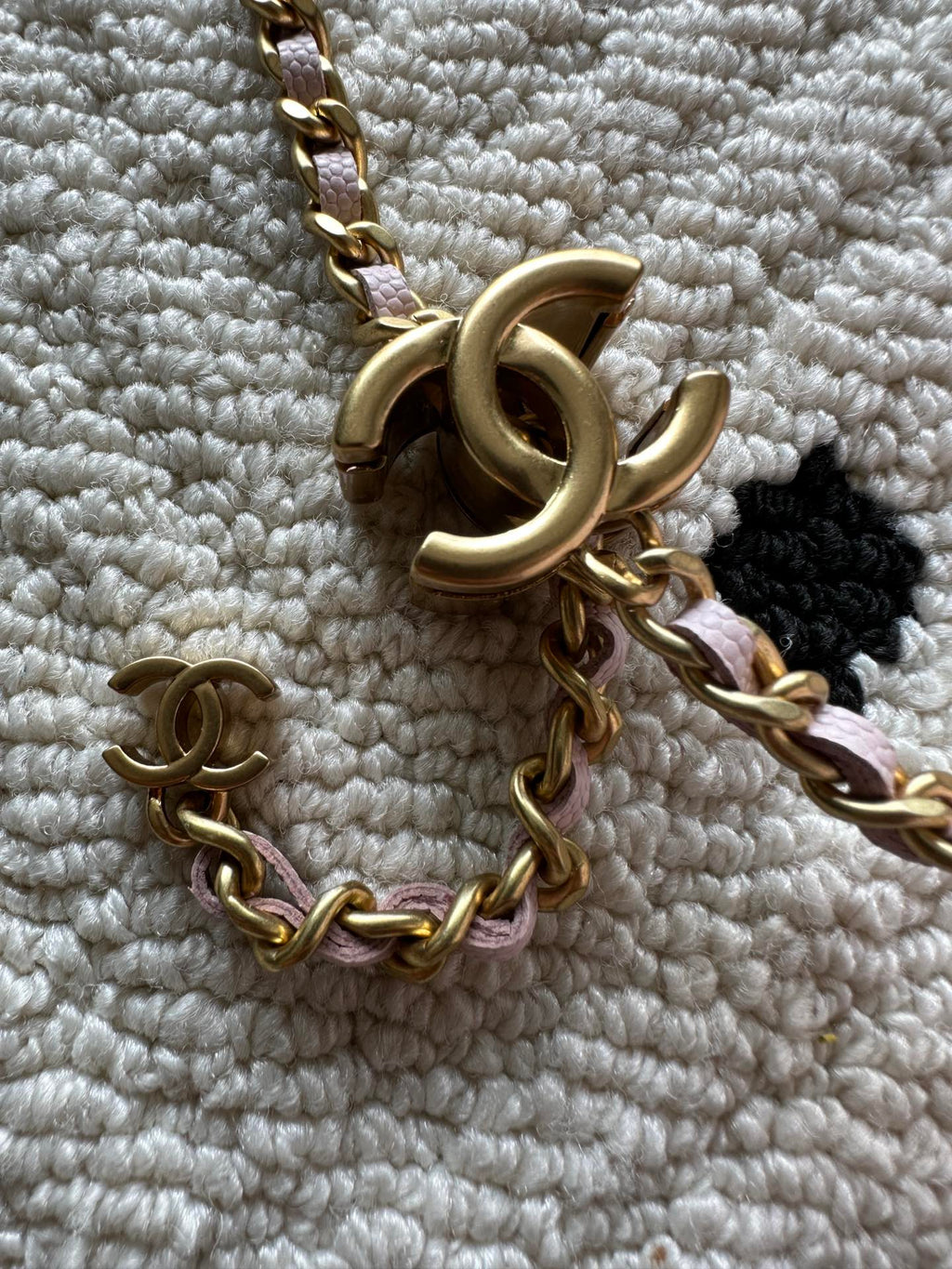 Gold chain and CC charm on Chanel bag clasp hardware