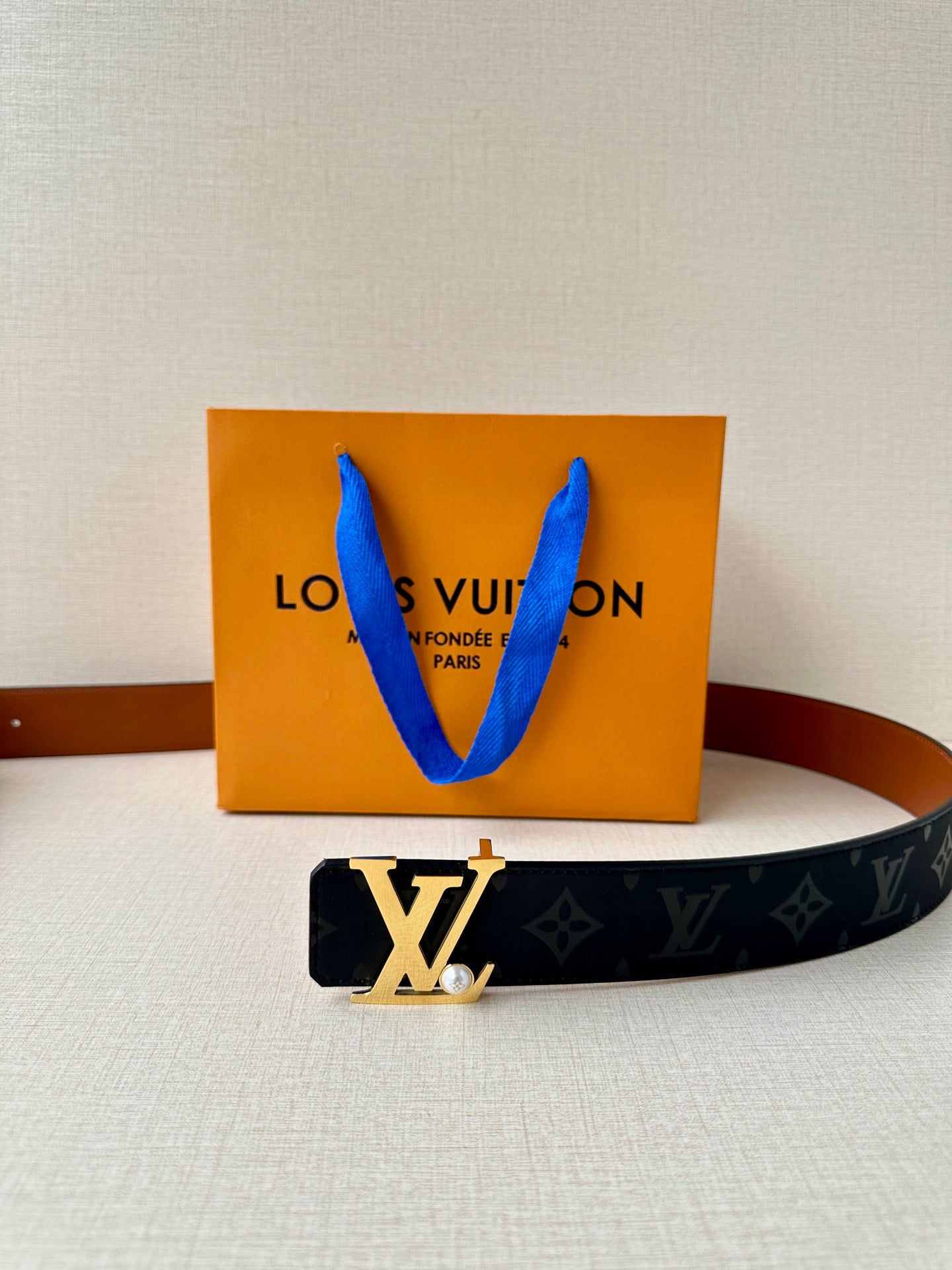 Louis Vuitton monogram belt with gold LV buckle and dark navy strap
