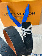 Louis Vuitton monogram belt with dark navy strap and prominent LV buckle detail