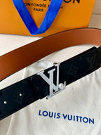 Louis Vuitton monogram belt close-up with metal LV buckle on dark navy strap