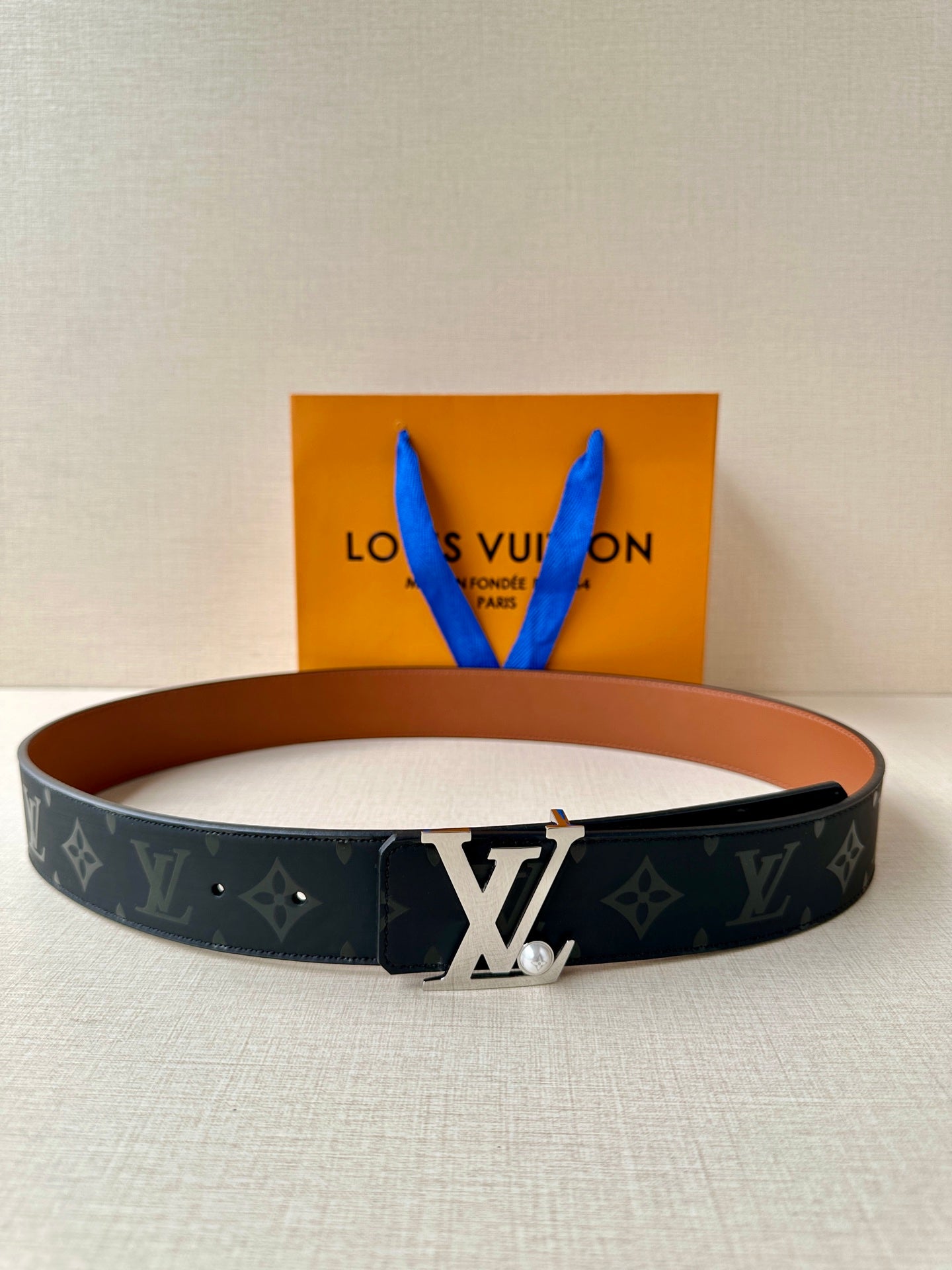 Louis Vuitton monogram belt with silver LV buckle and dark navy strap
