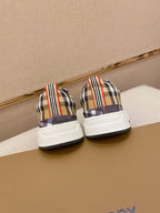 Pair of plaid low-top sneakers with white heel panels and striped collars