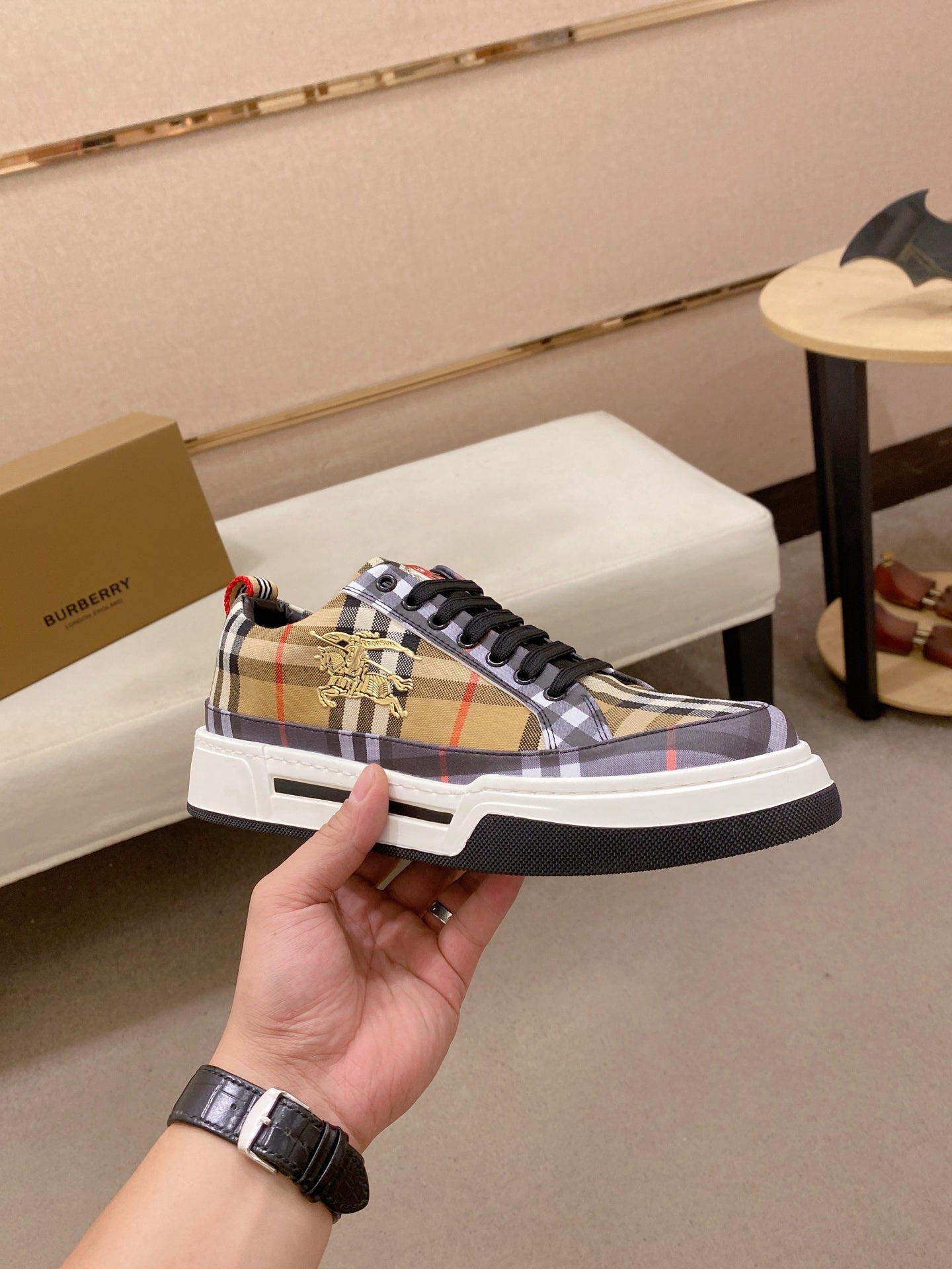 Plaid low-top sneakers with black laces and gold emblem on tongue, white rubber sole