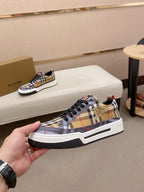 Plaid low-top sneakers with black laces, white midsole, and gold shield detail on side
