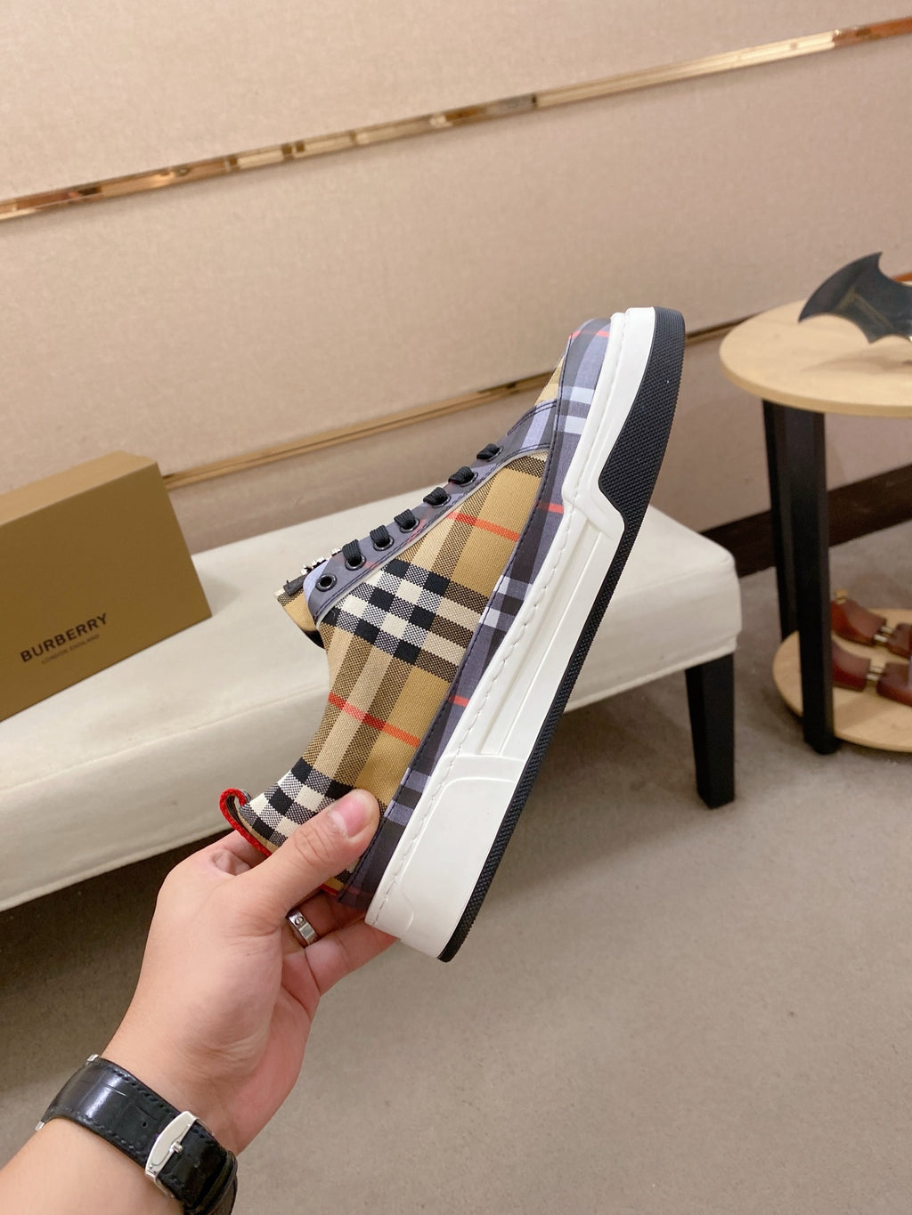 Plaid low-top sneakers with black lace panel and white sole, side view