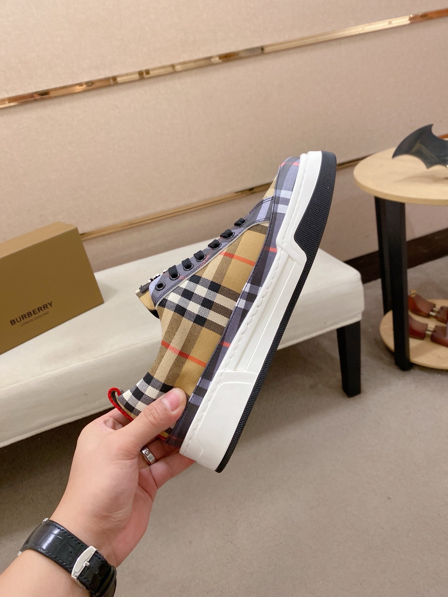 Plaid low-top sneakers with black lace panel and white sole, side view