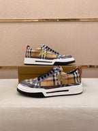 Pair of plaid low-top sneakers with black laces, white soles, red B logo accents