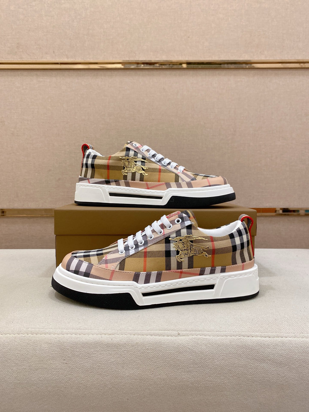 Plaid low-top sneaker pair on box, front and side view