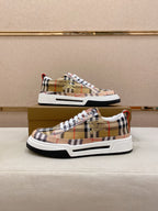 Plaid low-top sneaker pair on box, front and side view