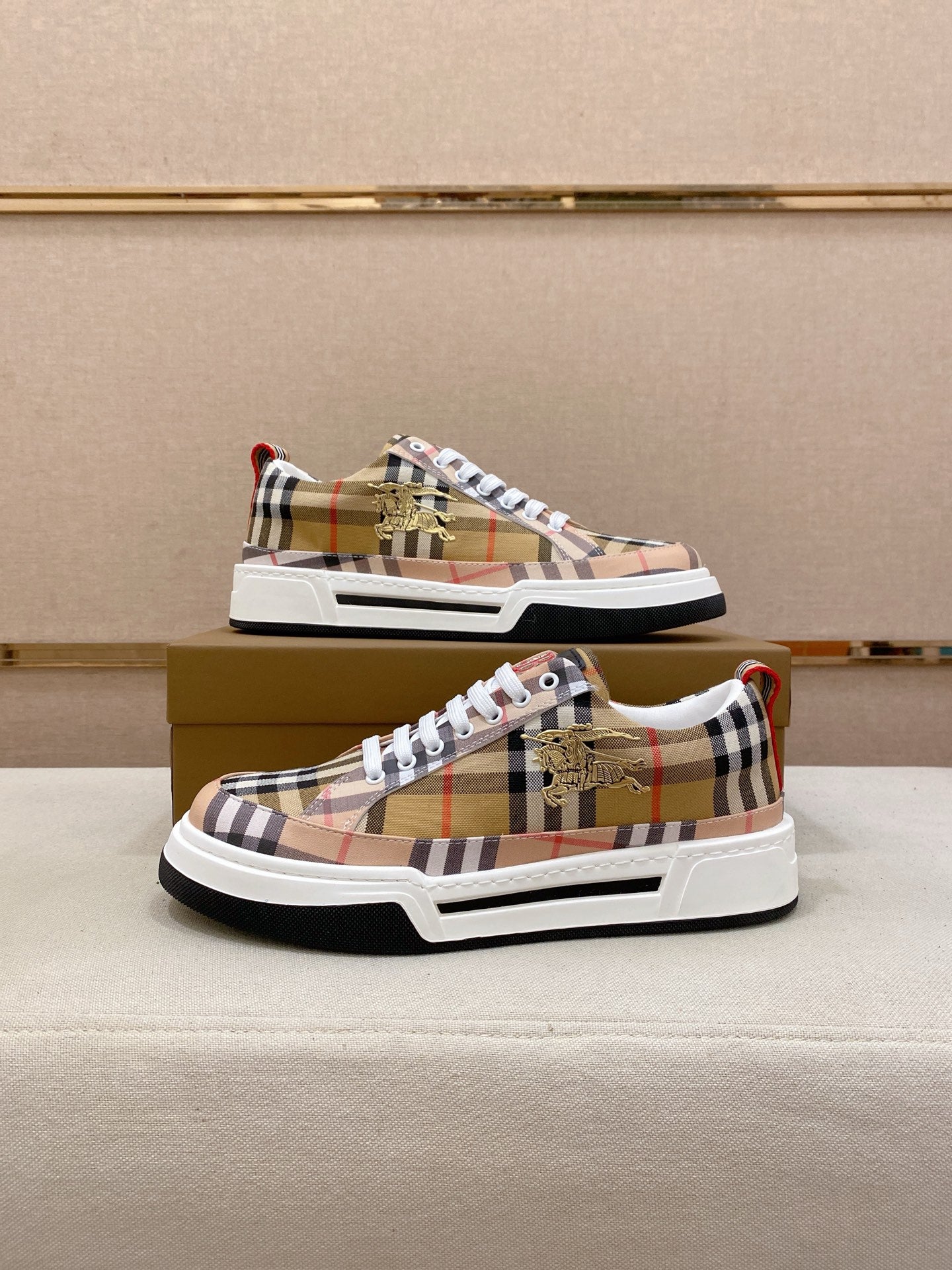 Plaid low-top sneaker pair on box, front and side view
