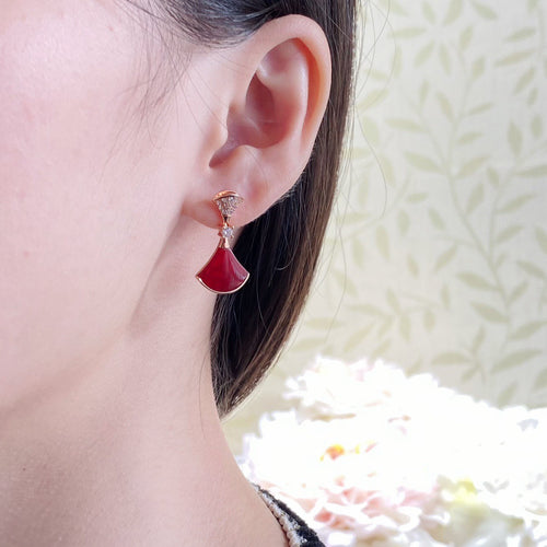 Gold-tone hoop earrings with red teardrop enamel and crystal pavé detailing