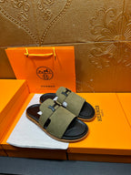 Olive suede slide sandals with H buckle straps and black rubber footbed