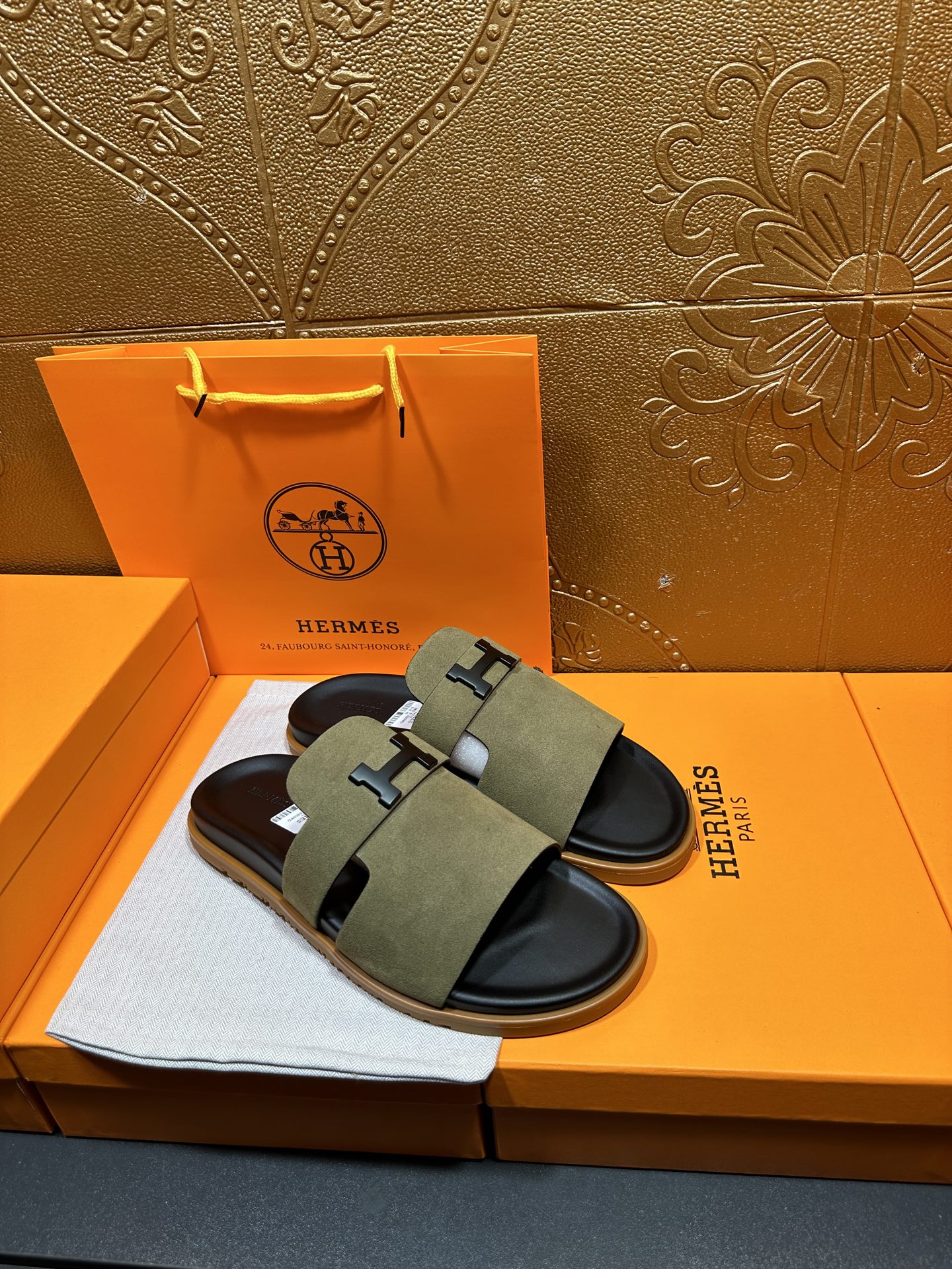 Olive suede slide sandals with H buckle straps and black rubber footbed