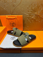 Olive suede slide sandals with H buckle detail and black molded footbed