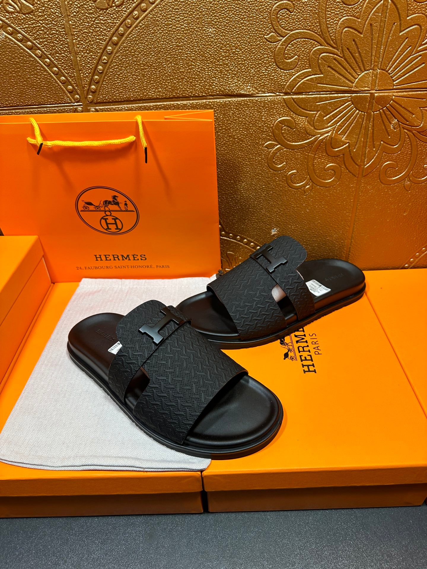 Black slide sandals with H buckle strap and textured footbed