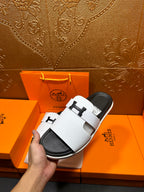 Hermes slide sandals, white strap sandals with black soles, side angle
